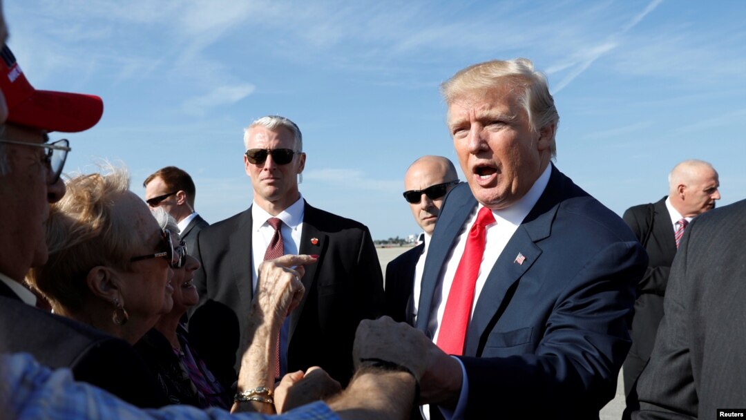 FILE - President Donald Trump greets well-wishers upon his arrival in West Palm Beach Florida, Feb. 17, 2017. 
