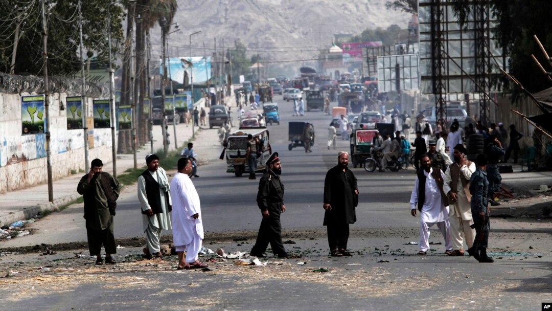 Afghan police officers inspect the scene after two bombs exploded at a Police checkpoint in the city of Jalalabad east of Kabul, Afghanistan, May 15, 2013.