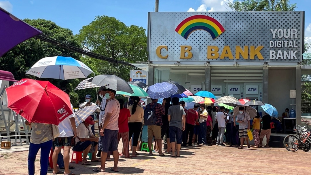 FILE - People line up outside a bank to withdraw cash, in Yangon, Myanmar, May 13, 2021.