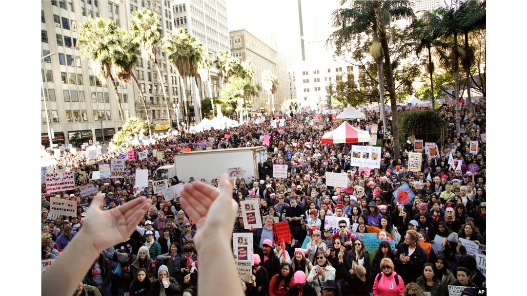 Protesters listen to a speaker as they gather for the Women's March against President Donald Trump, Jan. 21, 2017, in Los Angeles.
