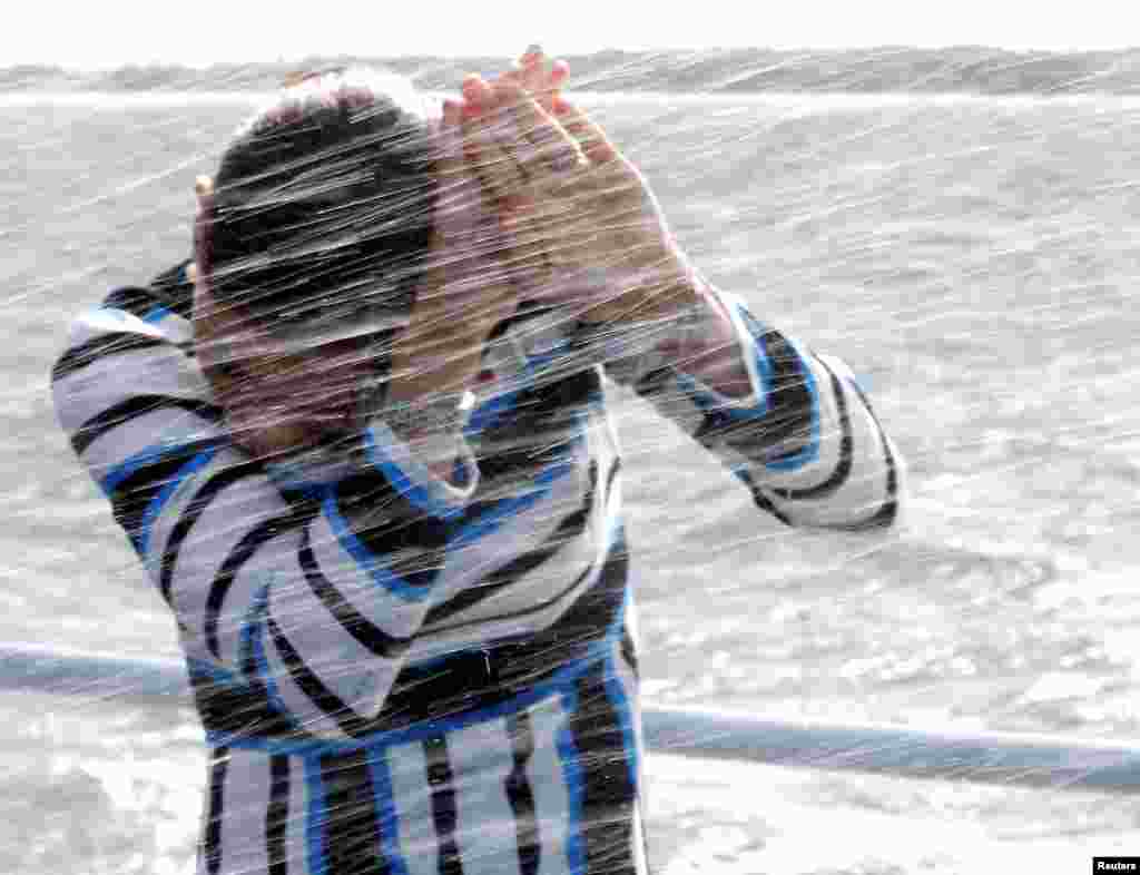 Sweden's Crown Princess Victoria covers herself from the water onboard of the Estonian Navy ship Wambola near Tallinn, Estonia.
