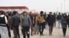 At a refugee camp outside Mosul, men gather to charge their phones, get their hair cut and tell tales of gruesome imprisonments for mundane crimes on Dec. 13, 2016 in Khazir, Iraq. (H.Murdock/VOA)