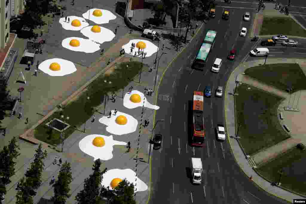 An art installation of giant fried eggs are seen as part of "Hecho en Casa" (Made at Home) urban artwork festival in downtown Santiago, Chile, Nov. 8, 2016.