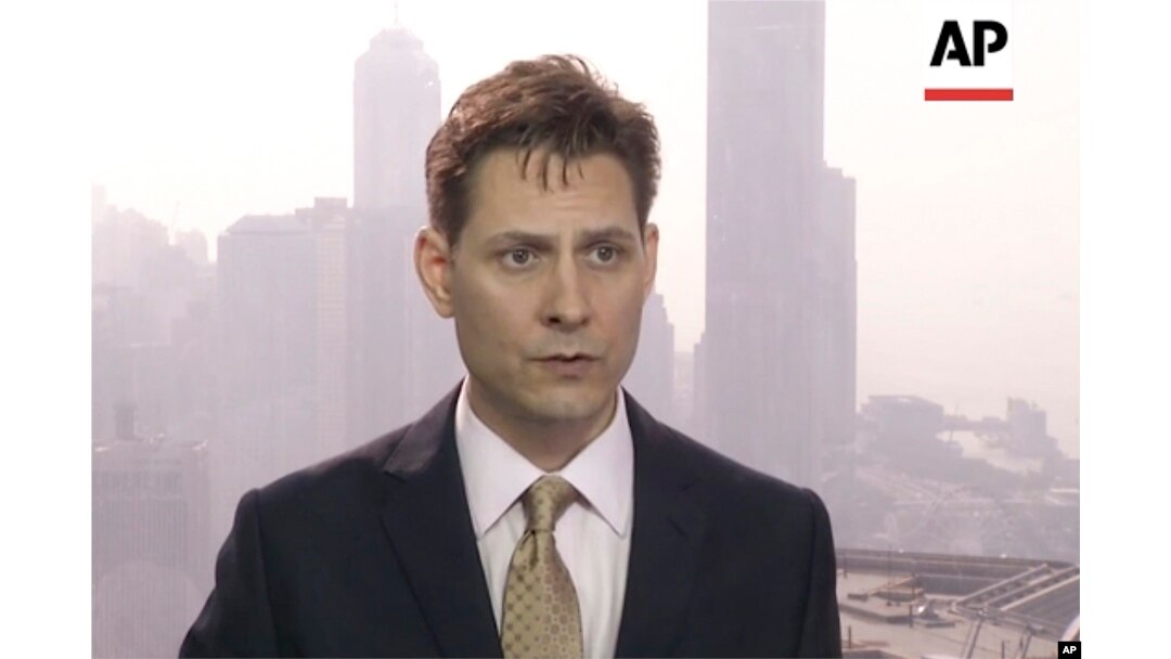 In this image made from a video taken on March 28, 2018, North East Asia senior adviser Michael Kovrig speaks during an interview in Hong Kong.