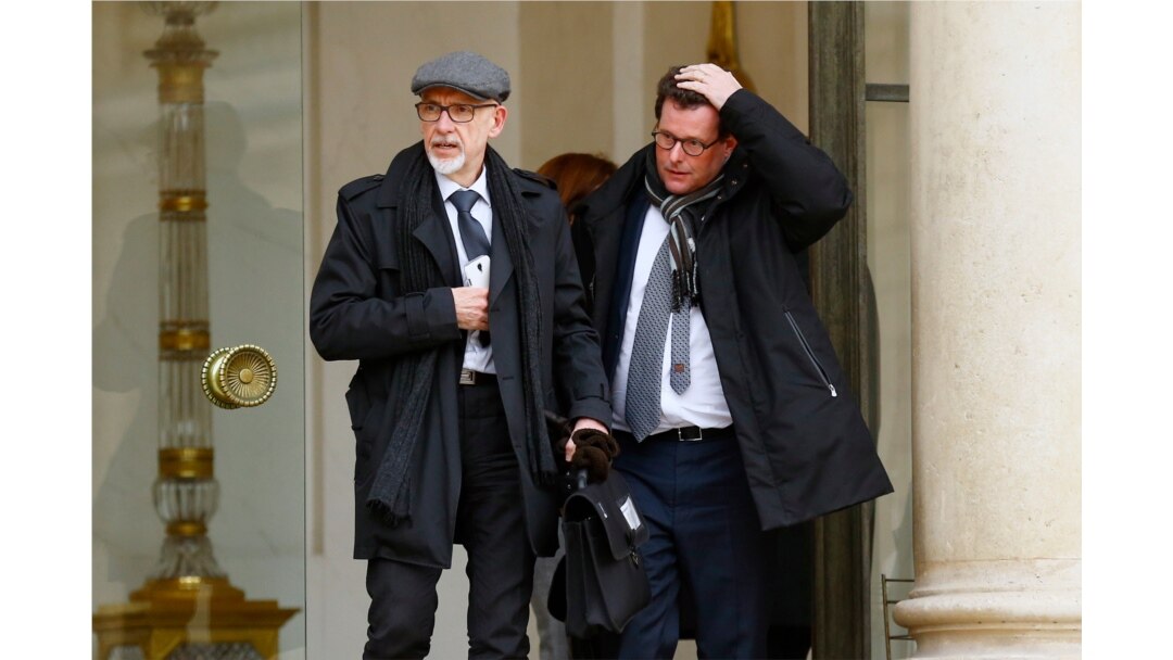 FILE - Georges Salines, left, whose daughter was killed in the 2015 Paris attacks by IS militants, and lawyer Jean Reinhart leave the Elysee Palace in Paris, after a meeting with French President Francois Hollande.
