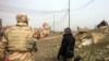 Iraqi soldiers travel to the frontlines as families flee in Mosul, Iraq, Jan. 23, 2017. (H. Murdock/VOA)