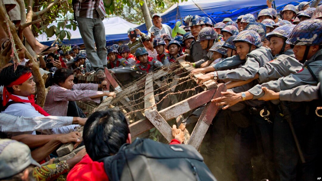 Student protesters struggle with riot police to remove a barricade during a protest against new education law in Letpadan, 140 kilometers (90 miles) north of the country's main city Yangon, Myanmar, March 10, 2015. Police arrested Kyaw Ko Ko, the leader of the student movement after he spent more than six months in hiding, a human rights monitoring group said.