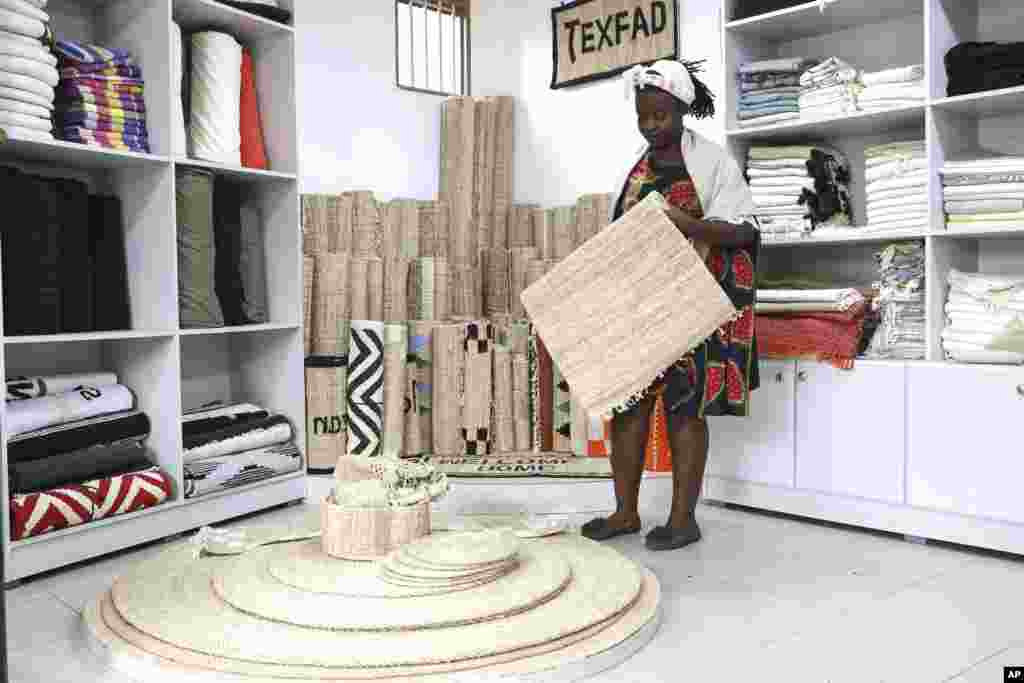 Beatrice Namawejje, marketing and sales personnel for TEXFAD, displays banana fiber products, at a showroom in Kira, Wakiso District, Uganda, Sept. 20, 2023. 