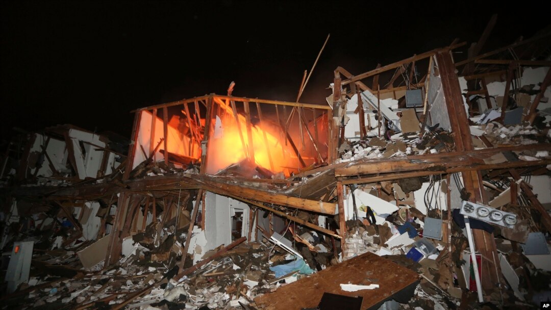 A fire still burns in a apartment complex destroyed near a fertilizer plant that exploded earlier in West, Texas, in this photo made early Thursday morning, April 18, 2013.