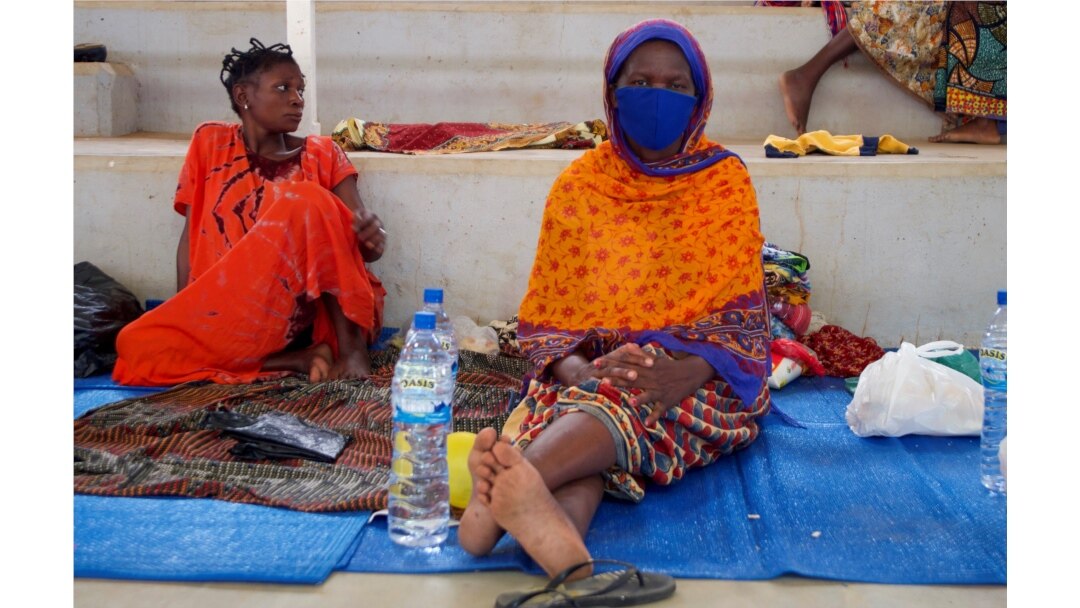 FILE - Displaced women sit on mats after fleeing an attack claimed by Islamic State-linked insurgents on the town of Palma, at a displacement center in Pemba, Mozambique, April 2, 2021.
