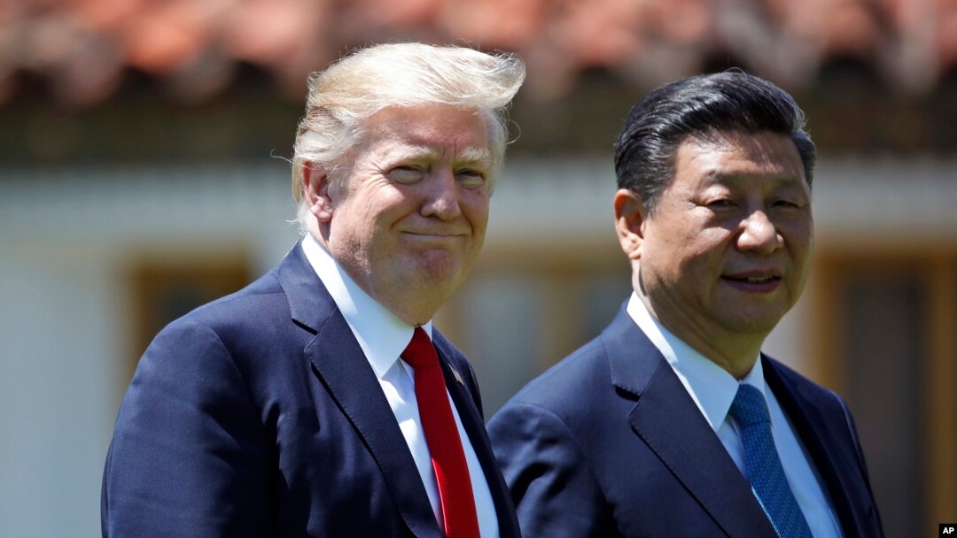 President Donald Trump and Chinese President Xi Jinping walk together after their meetings at Mar-a-Lago, April 7, 2017, in Palm Beach, Fla.