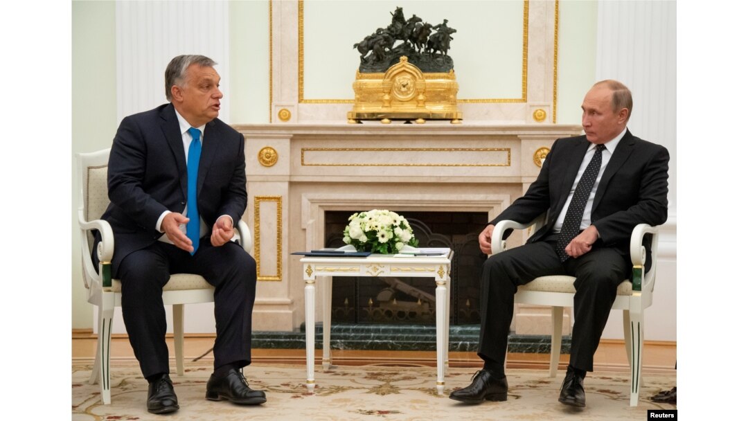 Hungarian Prime Minister Viktor Orban speaks with Russian President Vladimir Putin during their meeting at the Kremlin in Moscow, Sept. 18, 2018.