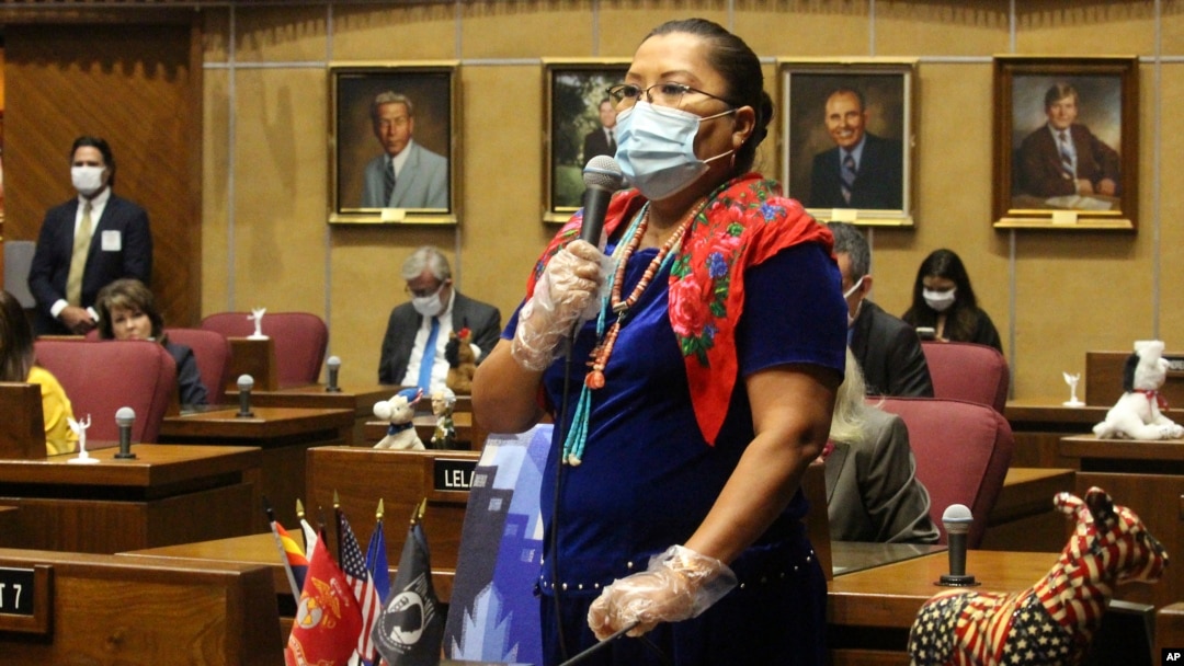 Democratic state Sen. Jamescita Peshlakai wears a mask as she tells member how the coronavirus has devastated the Navajo Nation while urging members to approve a move to end the legislative session at the state Capitol in Phoenix, May 8, 2020.