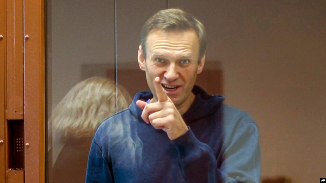 FILE - Russian opposition leader Alexey Navalny gestures during a hearing on his charges for defamation in the Babuskinsky District Court in Moscow, Russia, in this photo taken from a footage provided by the Babuskinsky District Court, Feb. 16, 2021.