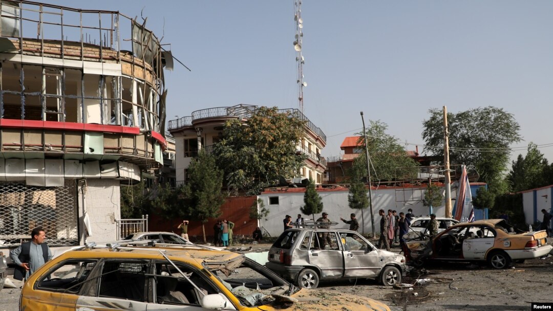 FILE - amaged cars are seen at the site of yesterday's night-time car bomb blast in Kabul, Afghanistan, Aug. 4, 2021.