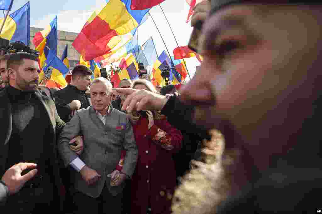 Calin Georgescu, the winner of Romania's first round presidential election, which the Constitutional Court later annulled, is surrounded by supporters during an event marking the anniversary of the 1859 unification of two provinces, a first step in the creation of the Romanian state, in Bucharest, Romania.