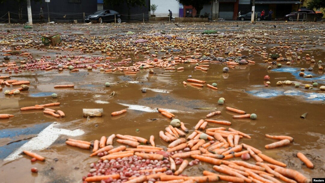 Fruits and vegetables lay on a muddy ground after heavy rain caused flooding in Franco da Rocha, Sao Paulo State, Brazil, Jan. 31, 2022.