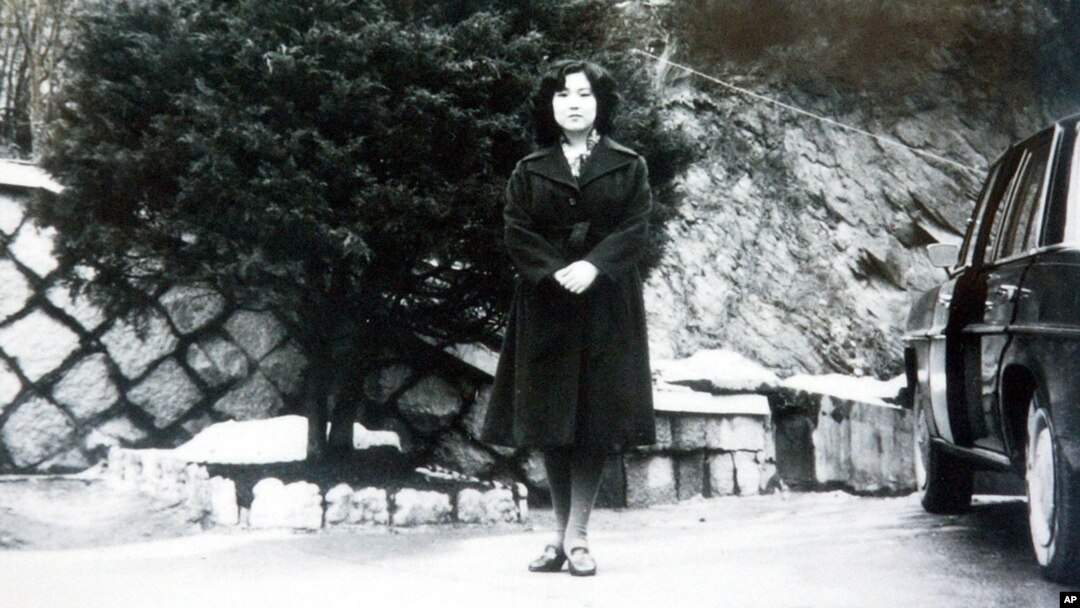 In this undated photo released Nov. 17, 2004, by the Tokyo-based National Association for the Rescue of Japanese Kidnapped by North Korea, Megumi Yokota stands by a car at an unknown place in North Korea after her abduction from her hometown in Japan. 