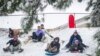 Snowstorm ices roads, closes schools, delays flights in southern US