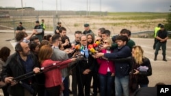 Newly-elected regional Catalan President Quim Torra, center, makes a statement to the media after visiting jailed Catalan politicians at the Estremera prison, near Madrid, Spain, May 21, 2018.