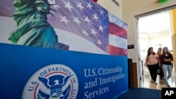 In this Aug. 17, 2018, file photo, people arrive before the start of a naturalization ceremony at the U.S. Citizenship and Immigration Services Miami Field Office in Miami.