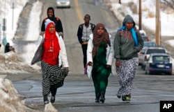 Students walk home from school in Lewiston, Maine, Jan. 26, 2016. Since February 2000, more than 5,000 Africans have come to Lewiston, a city of 36,500.