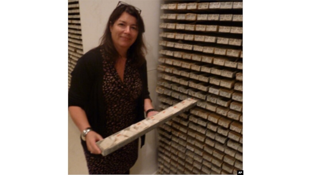 Core Repository Director Maureen Raymo pulls out a sea sediment sample, one of thousands at the archive.