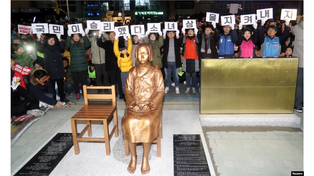 A statue of a girl representing World War II-era sexual victims of the Japanese military is seen during a rally in front of the Japanese consulate in Busan, South Korea, Dec. 31, 2016. Tokyo says the placement of yet another statue was a breach of a December 2015 deal struck between the two countries.