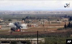 Image made from militant video posted online by the Aamaq News Agency, a media arm of the Islamic State group, Jan. 9, 2017, purports to show the moment of a Turkish missile strike, in the northern Syrian town of al-Bab, in Aleppo province, Syria.