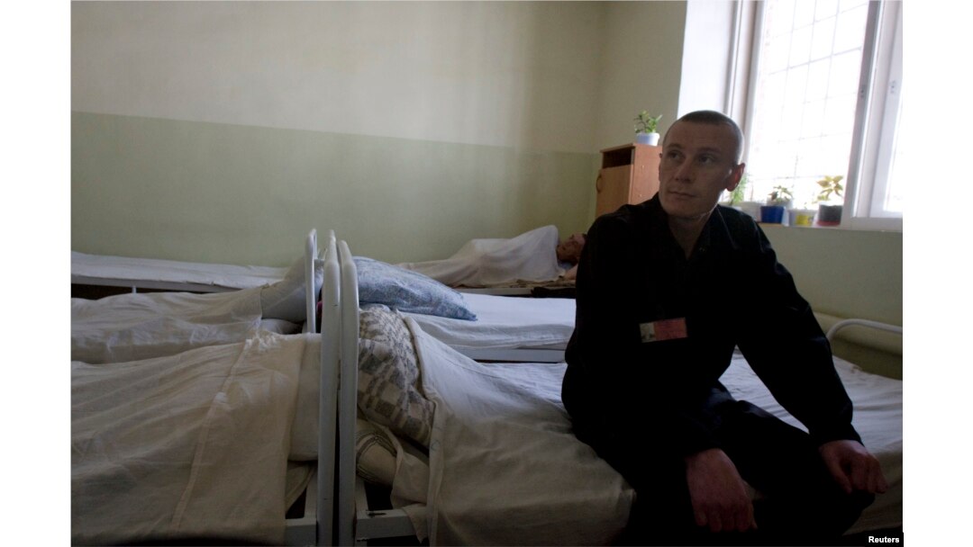 FILE - An inmate sits in the multi-drug-resistant tuberculosis ward in a prison hospital in Russia.