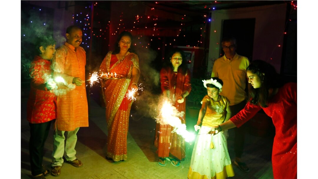 People play with firecrackers to celebrate during Diwali festival in Prayagraj, India, Thursday, Nov. 4, 2021. Diwali, the festival of lights, is one of Hinduism's most important festivals dedicated to the worship of Lakshmi, the Hindu goddess of wealth.