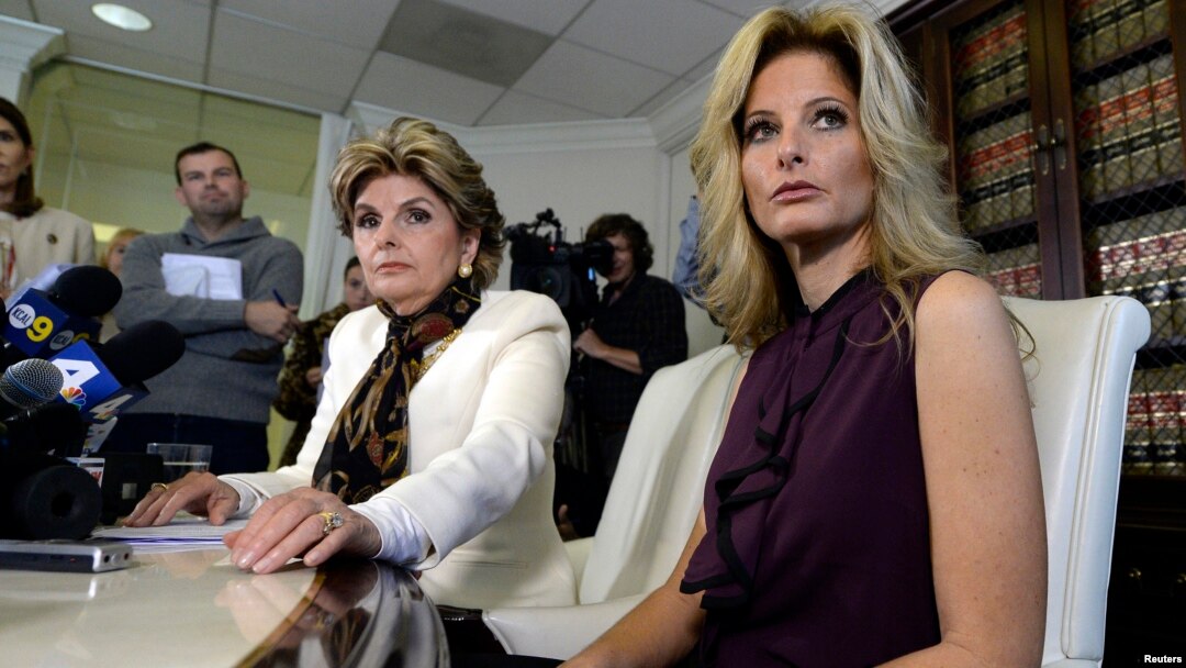 Summer Zervos, a former contestant on the TV show "The Apprentice," reacts next to lawyer Gloria Allred, left, while speaking about allegations of sexual misconduct against Donald Trump during a news conference in Los Angeles, Oct. 14, 2016.