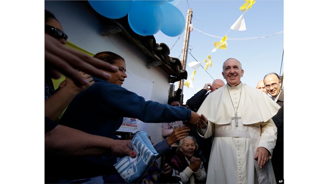 Pope Francis is greeted by the faithful during his visit to the Banado Norte neighborhood in Asuncion, Paraguay, July 12, 2015.