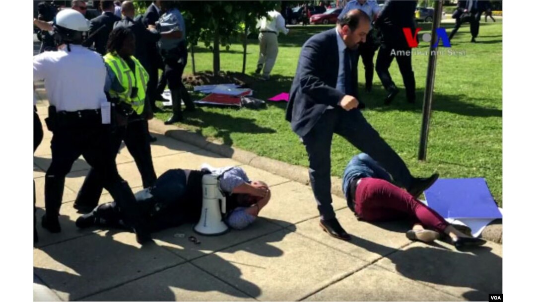 Demonstrators lie on the ground following a brawl with Turkish security personnel near the Turkish ambassador's residence in Washington, May 17, 2017. (screengrab from VOA Turkish video)