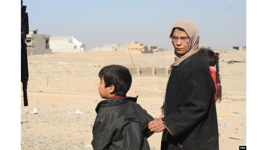 In the suburbs of Mosul, women seek food and medical care near army outposts. They say along with cruel indignities, Islamic State militants also brought with them wide scale extreme poverty on Nov. 19, 2016. (Photo: H.Murdock/VOA)