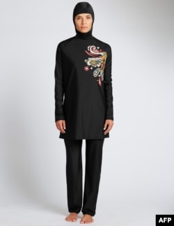 A model poses in a full-body bathing suit or burkini suit sold at Marks and Spencer's department store.