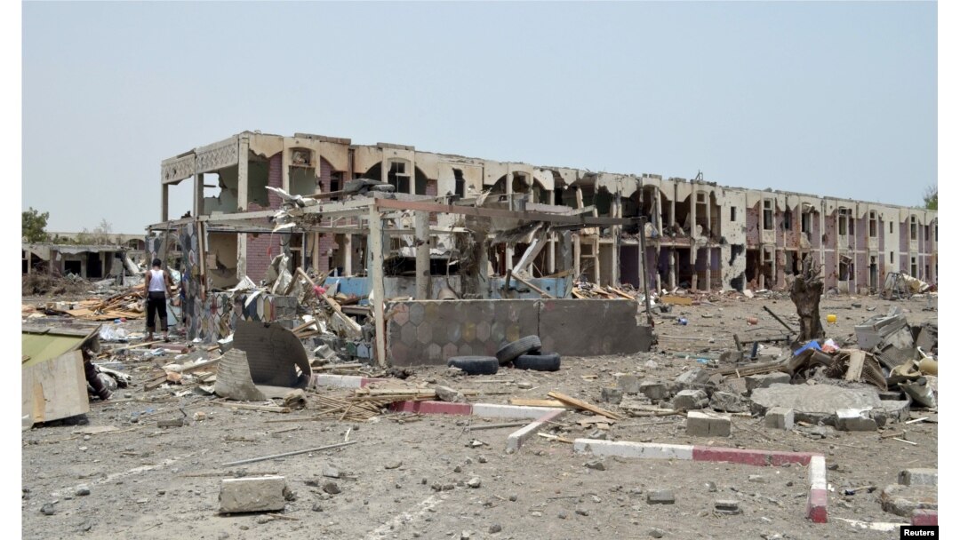 FILE - Damaged houses are seen one day after a Saudi-led air strike hit them in Yemen's western city of Mokha, July 26, 2015.