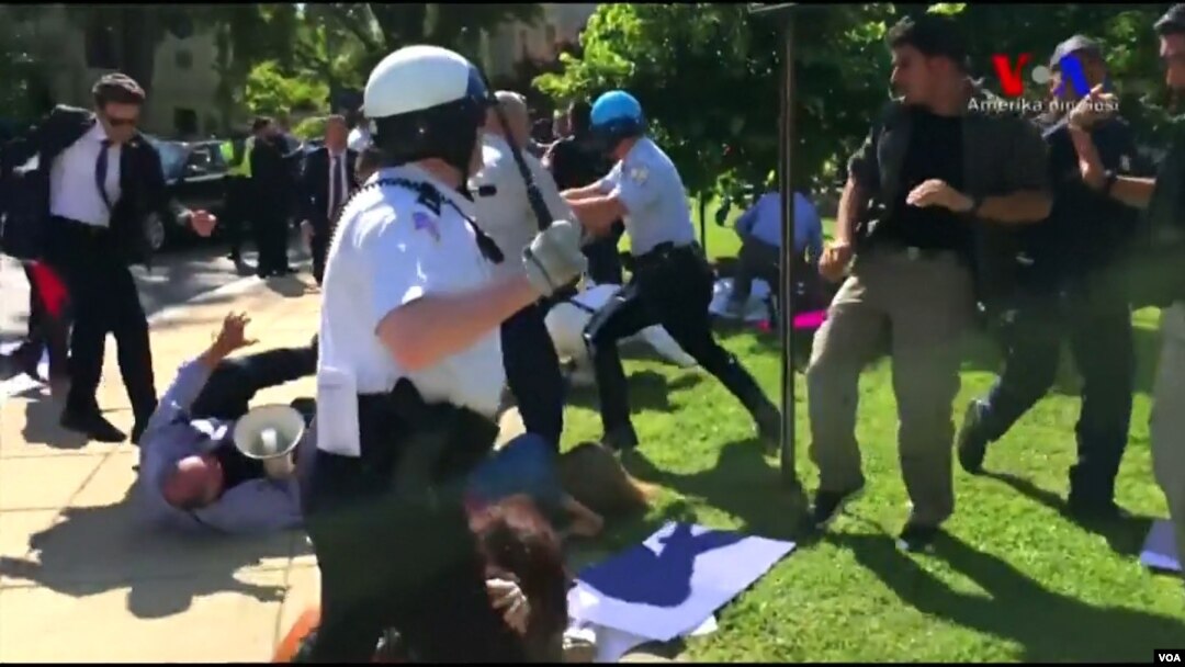 FILE - Police in Washington try to break up a clash between protesters and supporters of Turkish President Recep Tayyip Erdogan near the Turkish ambassador's residence, May 16, 2017, in this still image from video.