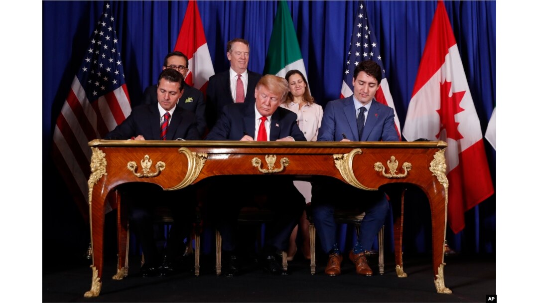 FILE - President Donald Trump, Canada's Prime Minister Justin Trudeau, right, and Mexico's then-President Enrique Pena Nieto, left, participate in the USMCA signing ceremony in Buenos Aires, Argentina, Nov. 30, 2018.