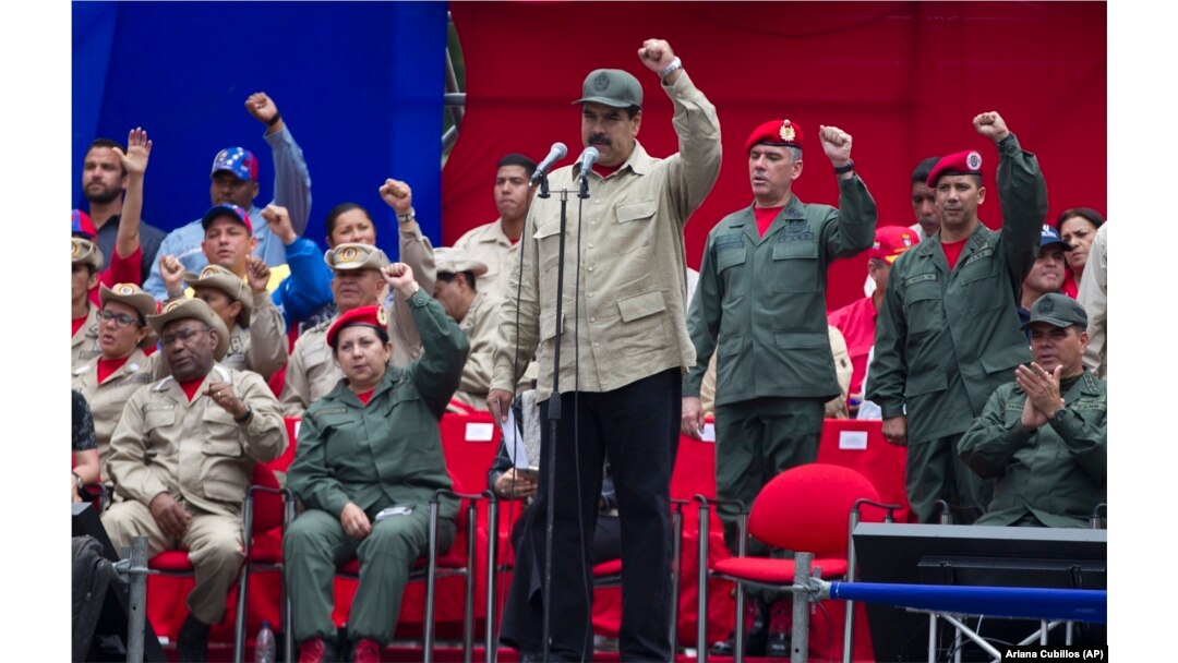 FILE - Venezuela's President Nicolas Maduro leads the seventh anniversary celebration of the Bolivarian Militia, in front of the Miraflores presidential palace in Caracas, Venezuela, April 17, 2017.