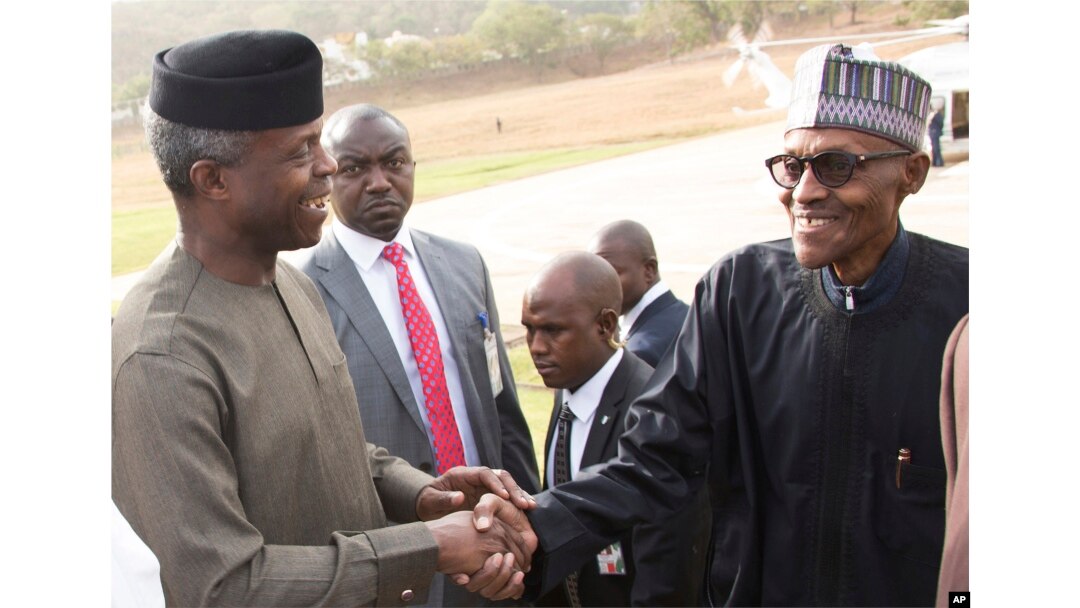 FILE - Nigeria President Muhammadu Buhari (right) is welcomed by Nigeria Vice President Yemi Osinbajo (left) upon arrival from his medical vacation in Abuja, Nigeria, March 10, 2017.