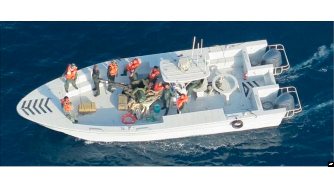 This image released by the U.S. Department of Defense on June 17, 2019, shows what the Navy says is the Islamic Revolutionary Guard Corps Navy after removing an unexploded mine from a tanker in the Strait of Hormuz.