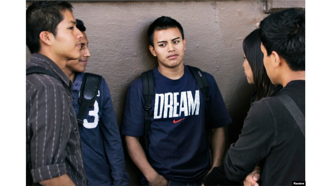FILE - Eddie Alberto, center, waits in line for assistance with paperwork for the Deferred Action for Childhood Arrivals program at the Coalition for Humane Immigrant Rights of Los Angeles in Los Angeles, California, Aug. 15, 2012.