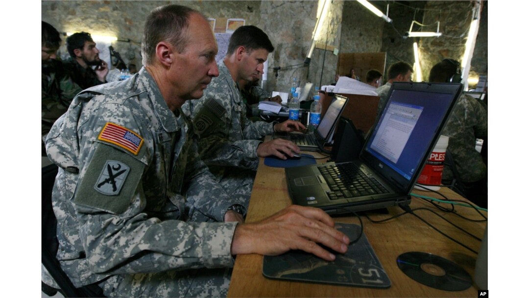 FILE - U.S. soldiers monitor battlefield conditions at a joint U.S.-Afghan command center in Ghazni province, west of Kabul, Afghanistan, June 21, 2007.