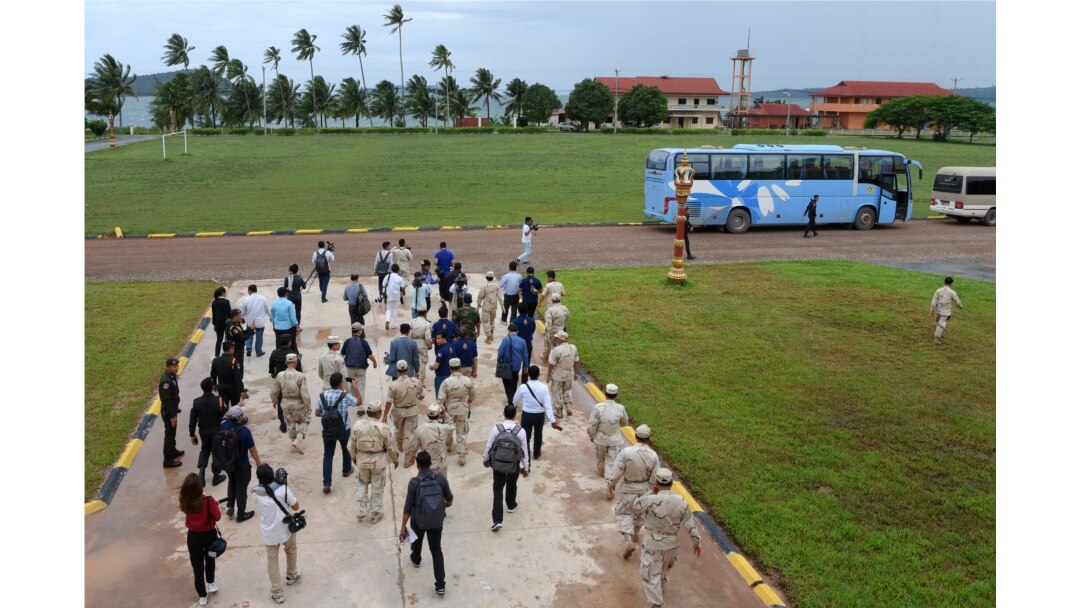 FILE - Cambodia naval personnel walk with journalists during a government organized media tour to the Ream naval base in Preah Sihanouk province on July 26, 2019.