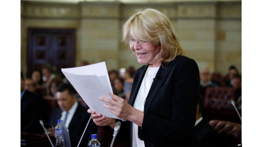 FILE - Former Venezuelan Chief Prosecutor Luisa Ortega shows documents that she claims prove that Venezuela's President Nicolas Maduro took bribes for the Brazilian construction company Odebrect, in Bogota, Colombia, April, 3, 2018.