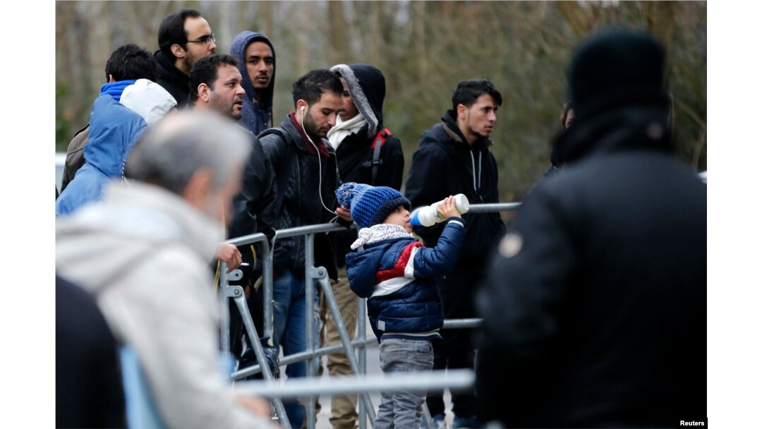 FILE - Migrants wait for their registration in front of the Federal Office for Migration and Refugees at Berlin's Spandau district, Germany, Jan. 29, 2016.