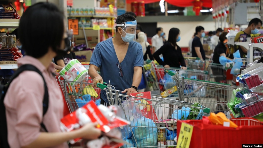 People line up to pay at a supermarket, amid the coronavirus disease outbreak in Kuala Lumpur, Malaysia, Jan. 12, 2021.