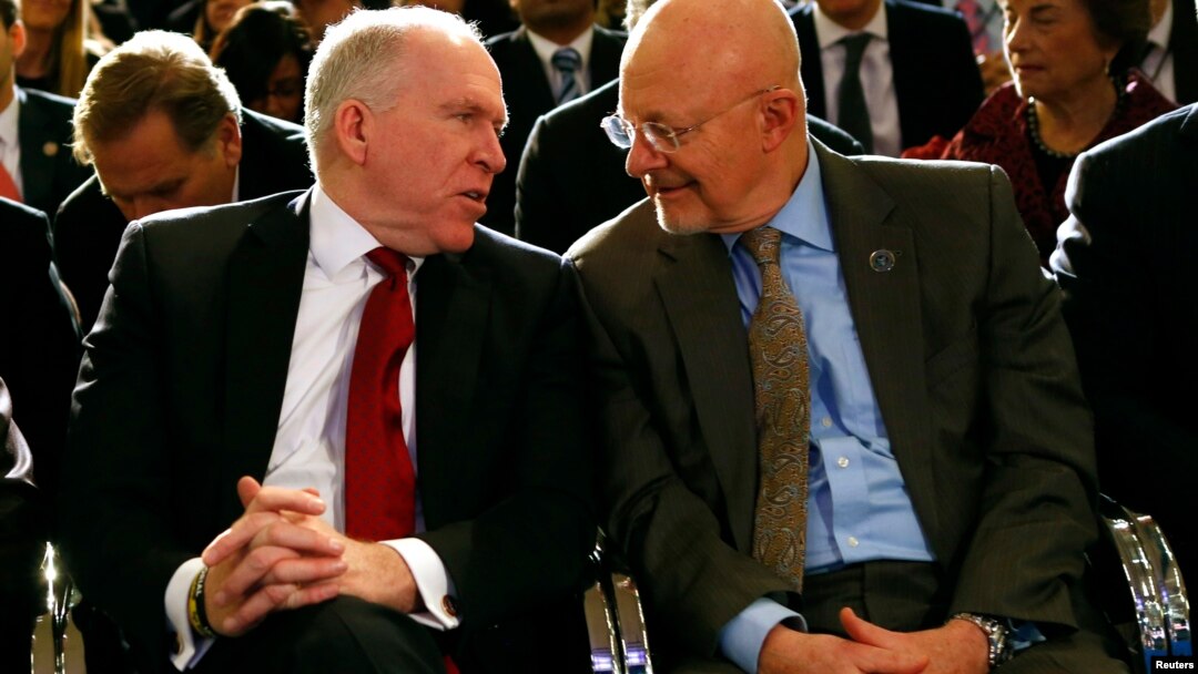 FILE - Then CIA Director John Brennan (L) speaks to then Director of National Intelligence James Clapper at the Justice Department in Washington, Jan. 17, 2014. Both Brennan and Trump had harsh words Friday for President Donald Trump at the Aspen Security Forum in Colorado.