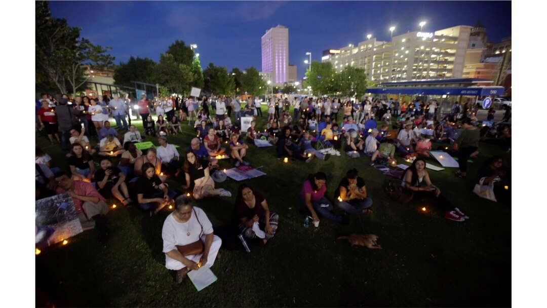 People with candles attend as immigration rights activists hold a "Lights for Liberty" candlelit vigil at Cleveland Square Park in El Paso, Texas, July 12, 2019.